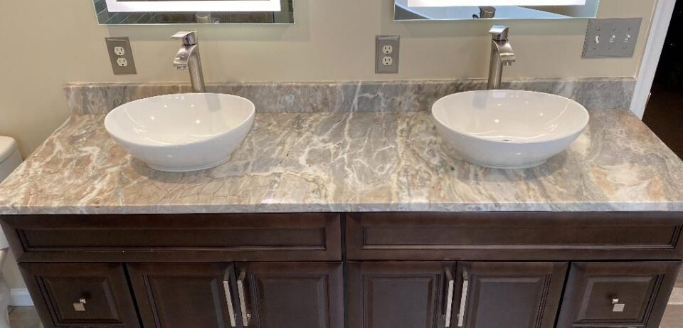 Bathroom vanity after remodel - stone countertop, vessel sinks and new cabinetry