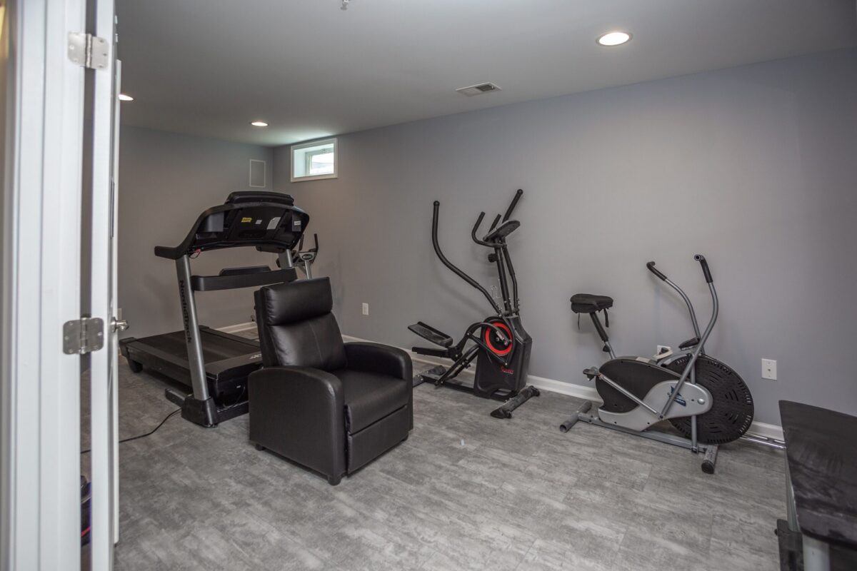 Finished basement home gym with treadmill, elliptical and exercise bike