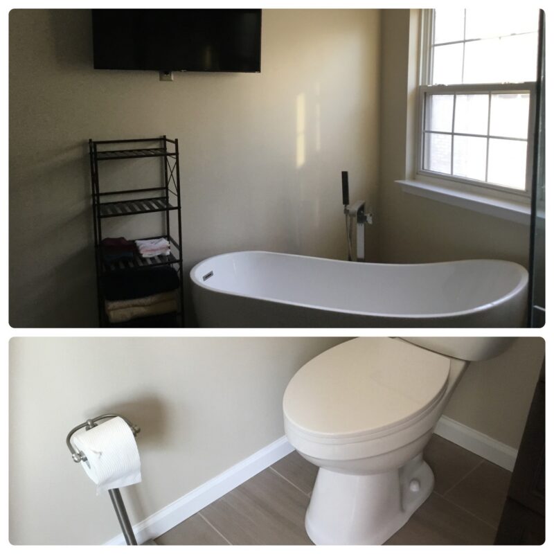 Remodeled bathroom with freestanding tub and new toilet
