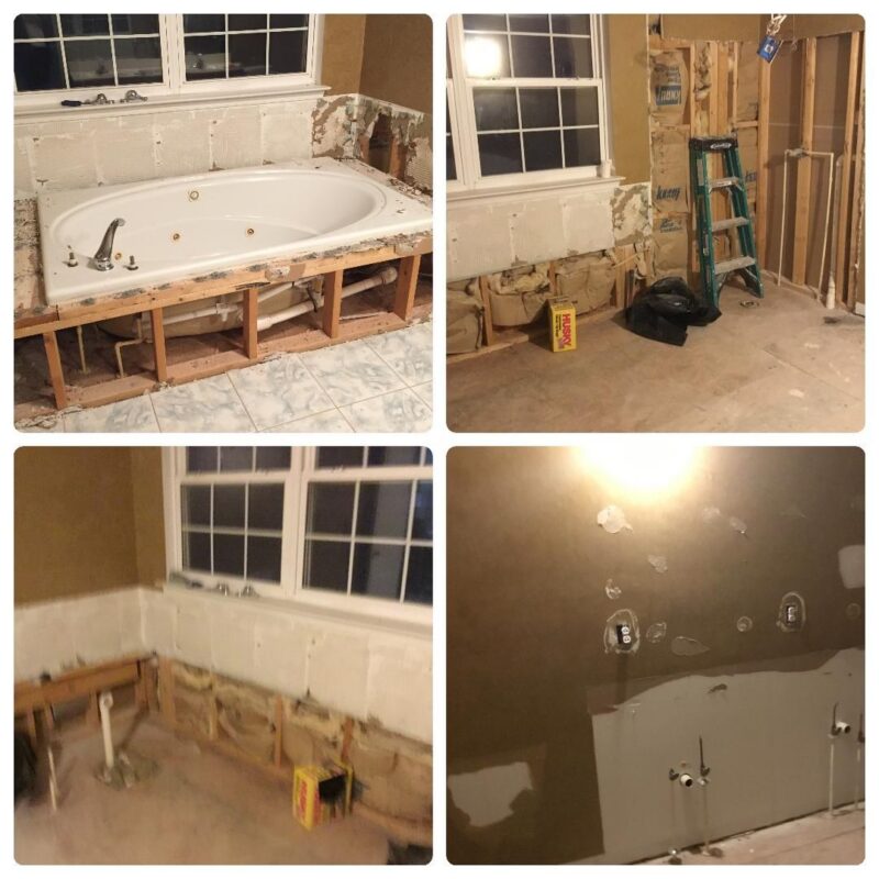 Bathroom demolition in progress with old jetted tub removed