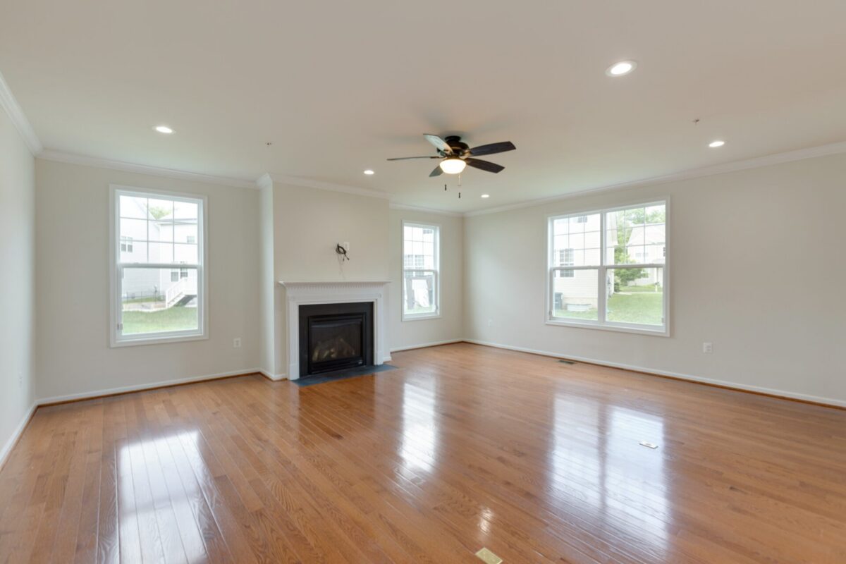 Living room with hardwood floors, fireplace and ceiling fan