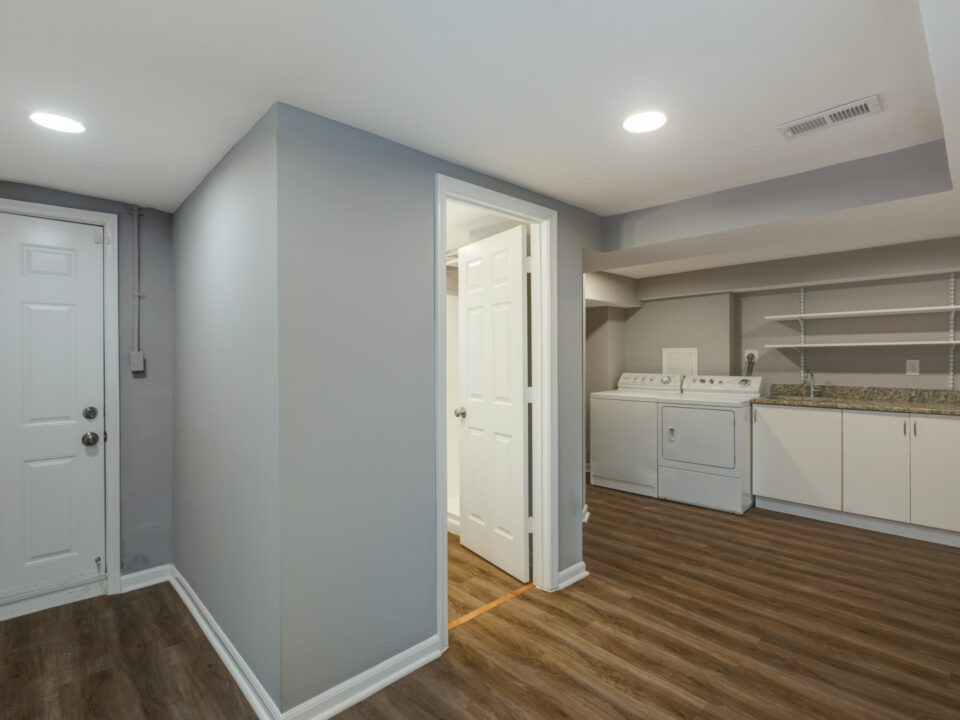 Remodeled lower level with laundry area, plank flooring and new doors