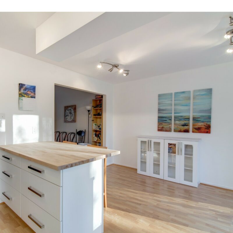Kitchen island with butcher block top and white cabinets