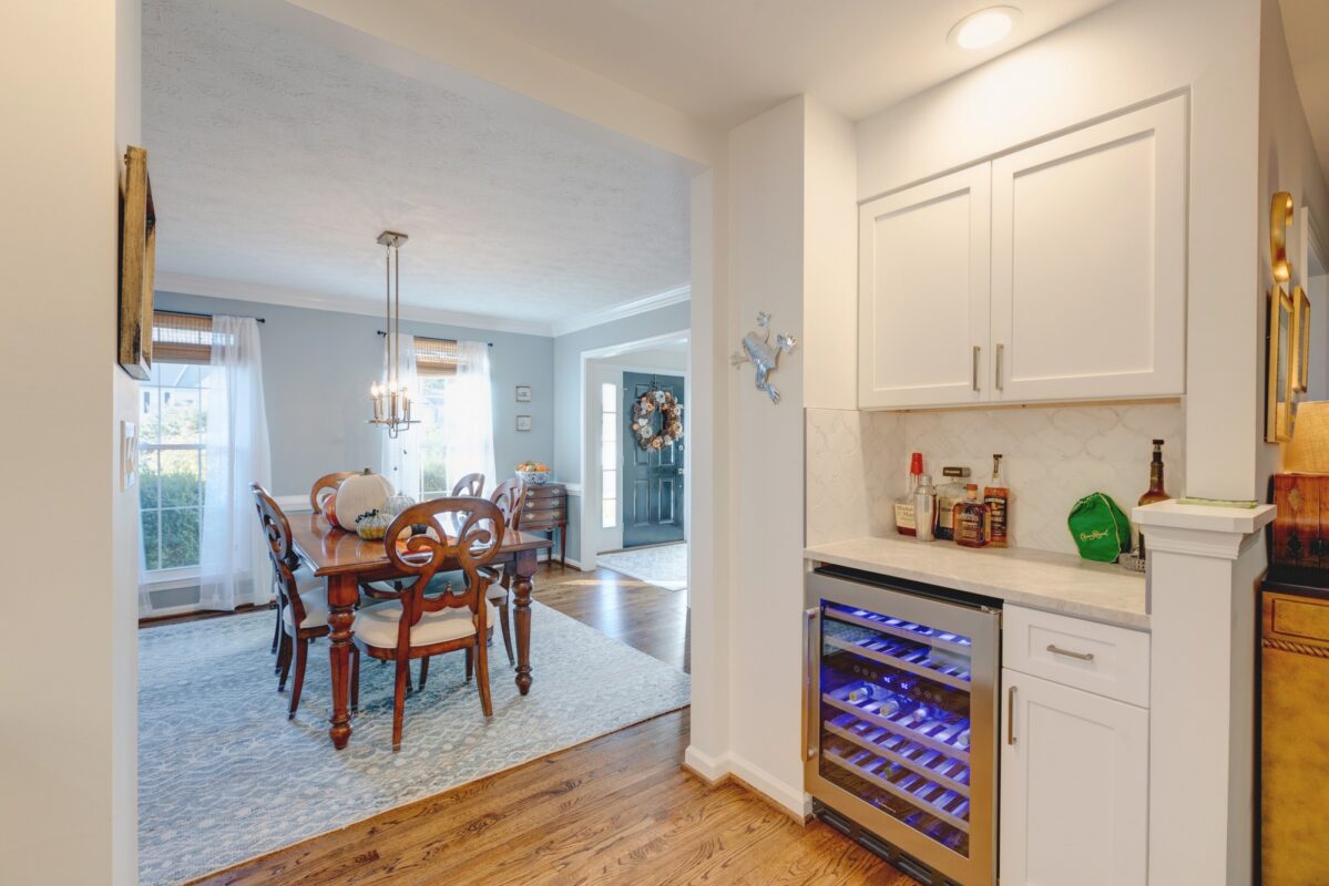 Kitchen beverage center with wine fridge opening into the dining room